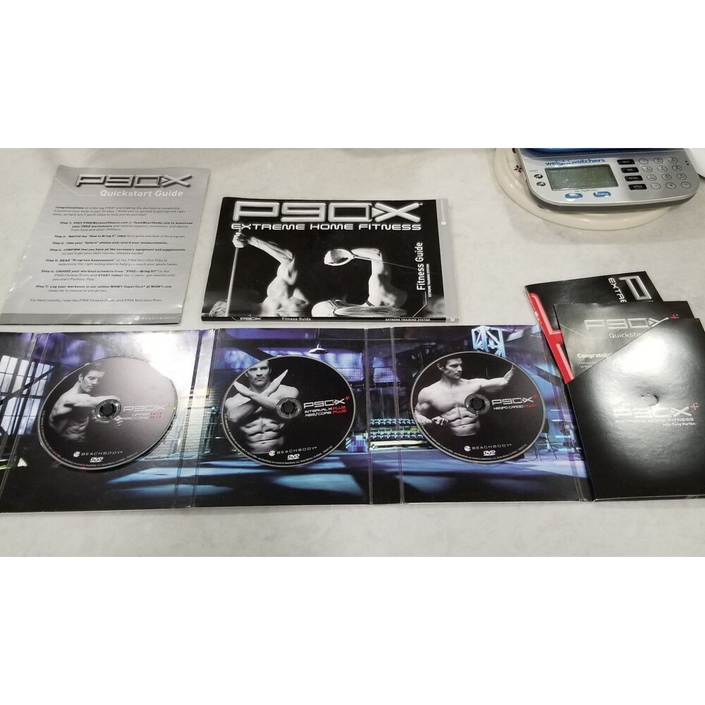 P90X plus Extreme Home Fitness workout DVD set and documents